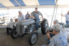 Phil Fenner of Kent, Washington, and Jeff Miller of Goshen, Ohio, holding a clinic showing how to determine engine compression, using Jeff's 1948 Ferguson TE-20.