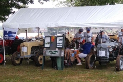 The Sprague’s tent with their tractors. The one on the right had hand controls added and place to put crutches. Hand controls outfitted for their father Paul Jr. who had polio.